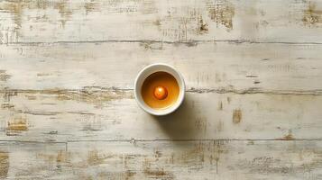 An egg in a bowl on a wooden table photo