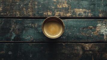 A golden cup on a wooden table photo