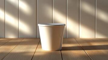 A white cup sitting on a wooden table photo