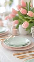 Beautiful spring tablescape with pastel dishes and pink tulips for a special gathering photo