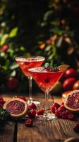 Refreshing cocktails served in elegant glasses with fresh fruits and herbs on a wooden table photo