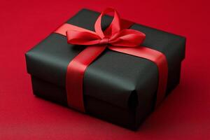 Elegant black gift box with red ribbon on vibrant red background photo
