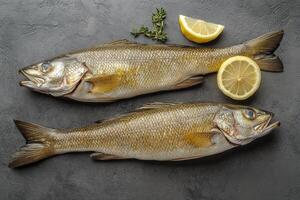 Freshly caught fish ready for preparation in a culinary setting on a stone surface photo