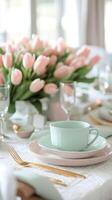 Beautiful spring tablescape with pastel dishes and pink tulips for a special gathering photo