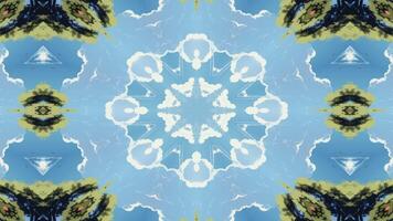 A symmetrical design featuring clouds against a blue sky, creating a kaleidoscopic effect. video
