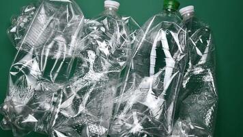 Waste sorting time lapse top view. Hands fold transparent PET plastic bottles, used plastic bags and paper cardboard for recycling. Reuse reduce recycle household trash. Go green and zero waste video