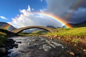 Stunning rainbow over a stone bridge in a scenic mountain landscape photo