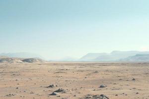 Vast desert landscape with mountains in the distance photo