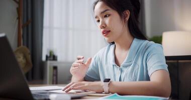 Footage of handheld, Female freelancer having call meeting with team and presenting project with laptop in home office. Work from home ,Remote work video