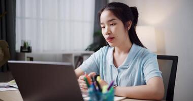 Footage of handheld, Female freelancer having call meeting with team and presenting project with laptop in home office. Work from home ,Remote work video