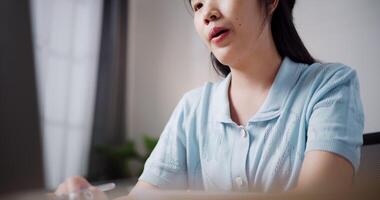 Handheld low angle view shot, Female freelancer explaining project in online meeting with team members via laptop in home office. Working from home, Remote working. video