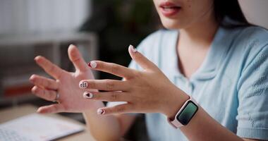 Handheld selective focus shot, Hands of Female freelancer explaining project in online meeting with team members via laptop in home office. Working from home, Remote working. video