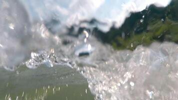 Extreme rafting on a mountain river. The camera shakes dynamically and plunges under water, splashes and drops of water on the camera lens. video