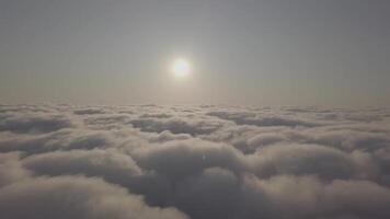View from a drone on a sea of clouds to the horizon at dawn video