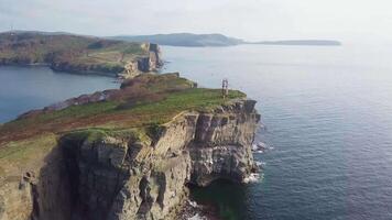 Drone view of a peninsula Tobizina with vertical cliffs at sunrize. video