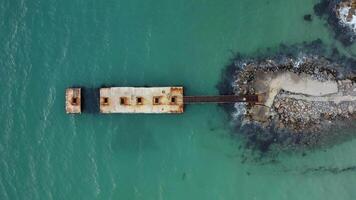 Old pier in the sea, surrounded by clear turquoise water. Relaxation landscape video