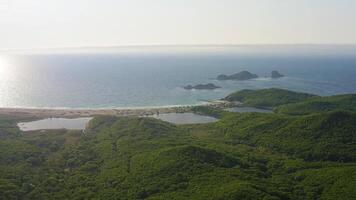 Drone view of a beautiful sandy beach with clear water at dawn. Seascape video
