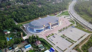 Drone view of the Fetisov Arena sports complex, surrounded by green hills video