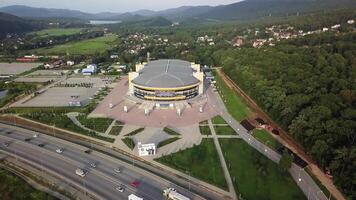 Drone view of the Fetisov Arena sports complex, surrounded by green hills video