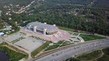 Drone view of the Fetisov Arena sports complex, surrounded by green hills video