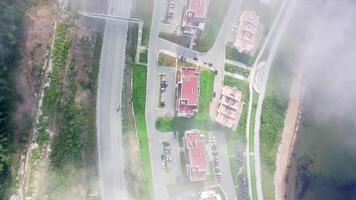 Drone view of the city by the sea. Part of the buildings is covered with fog. video