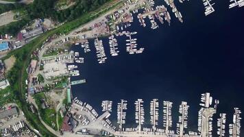 View from the drone vertically down to the bay with piers and yachts. video