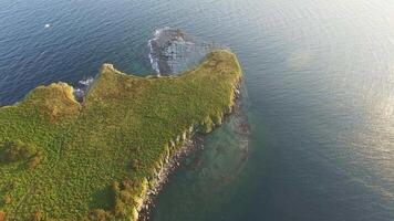 Aerial. Magnificent summer beauty of rocky cape, with sheer cliffs and beaches at sunset video