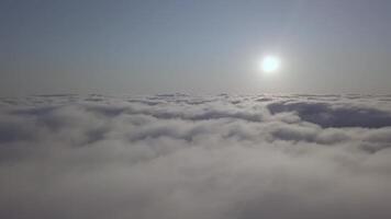 View from a drone on a sea of clouds to the horizon at dawn video