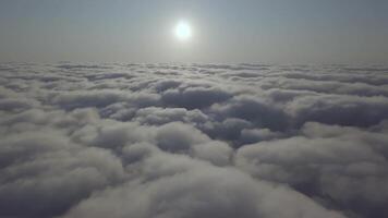 View from a drone on a sea of clouds to the horizon at dawn video