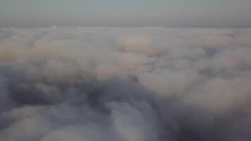 View from a drone on a sea of clouds to the horizon at dawn video