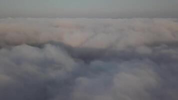 View from a drone on a sea of clouds to the horizon at dawn video