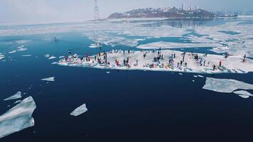Drone view of a people on standing boards with an oar on an ice floe video