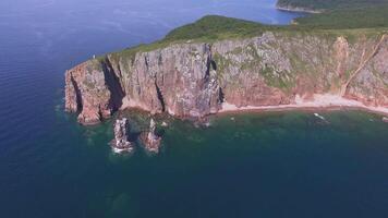 View from a drone of the coastline with a rocky coast island of Shkot video