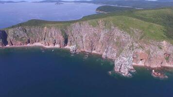 View from a drone of the coastline with a rocky coast island of Shkot video