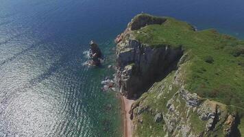 View from a drone of the coastline with a rocky coast island of Shkot video