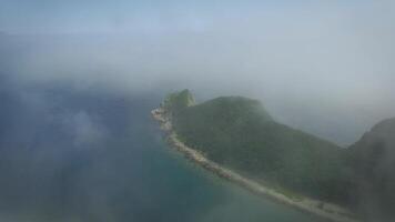 Drone shoot along the coast on a sunny day shrouded in fog. video