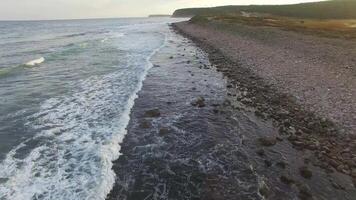 Drone view of the sea coast with rocky shore and waves video