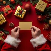 Holiday spirit shines with gifts and a blank card held by festive hands in a cozy setting photo