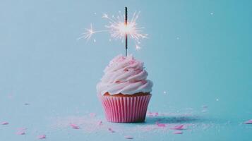 Sparkling cupcake with pink frosting on a blue background for celebration purposes photo