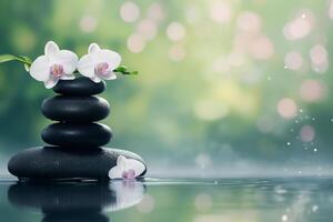 Tranquil spa setting with stacked stones and white orchids near serene water surface photo