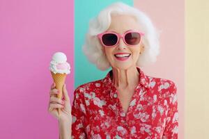 Joyful elderly woman enjoying ice cream against a pink background photo