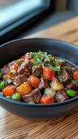 Delicious beef stew with vegetables served in a black bowl at a cozy kitchen setting photo