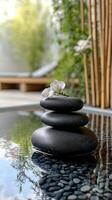 Relaxing spa setting with stacked stones and orchids in tranquil water photo