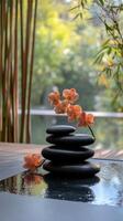 Relaxing spa setting with stacked stones and orchids in tranquil water photo