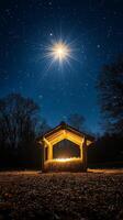 Starry night over a rustic shelter with hay under a glowing light in the countryside photo