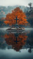 Mysterious cross surrounded by fog and autumn trees by a quiet lake at dawn photo