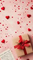 Celebration gift box with red hearts on pink background for special occasions photo