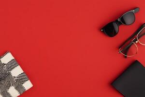 Stylish accessories arranged on a vibrant red background for a trendy look photo