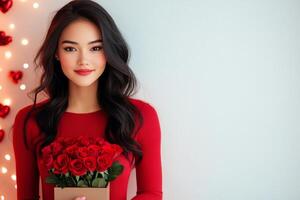 Woman in red dress holding roses in front of a vibrant red background during a celebration photo