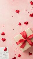 Celebration gift box with red hearts on pink background for special occasions photo